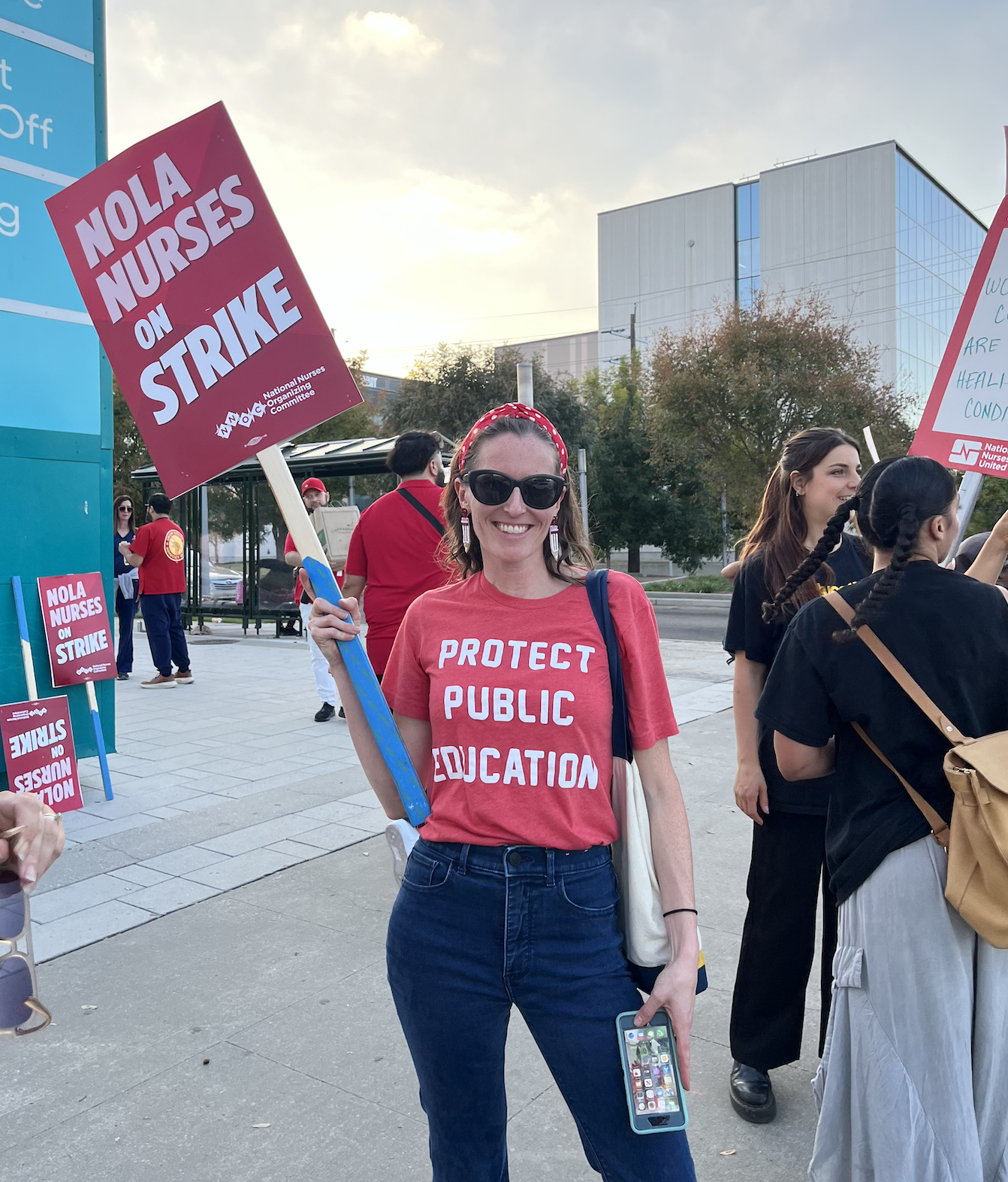 Lauren Jewett supporting striking New Orleans nurses while wearing a Protect Public Education shirt